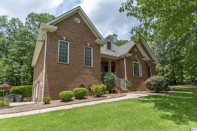 8587 Hayes Rd, Helena, AL 35022 - traditional home featuring brick siding, a front lawn, and roof with shingles