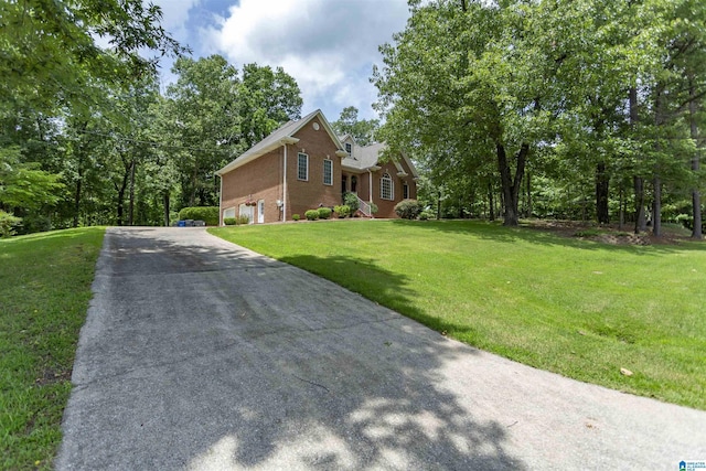 8587 Hayes Rd, Helena, AL 35022 - view of side of property featuring brick siding, concrete driveway, a garage, and a lawn