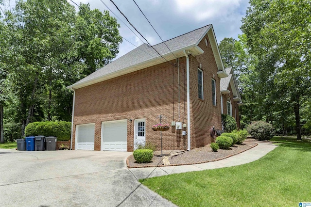 8587 Hayes Rd, Helena, AL 35022 - view of property exterior with concrete driveway, a garage, brick siding, and a lawn