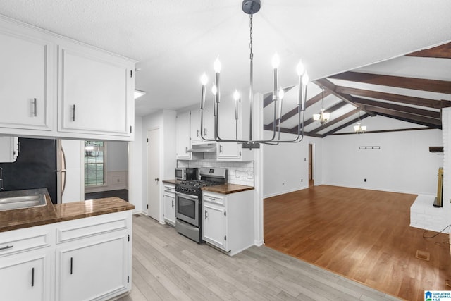 2005 Crossvine Rd, Hoover, AL 35244 - kitchen with stainless steel appliances, light wood-style floors, a chandelier, and white cabinets