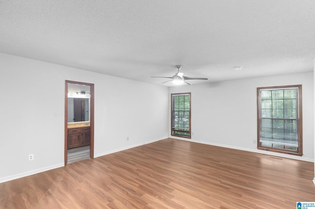 2005 Crossvine Rd, Hoover, AL 35244 - unfurnished room featuring a ceiling fan, wood finished floors, and a textured ceiling