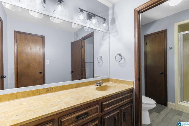 2005 Crossvine Rd, Hoover, AL 35244 - full bathroom featuring a stall shower, vanity, and wood finished floors