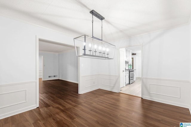 2005 Crossvine Rd, Hoover, AL 35244 - unfurnished dining area featuring a chandelier, wood finished floors, wainscoting, a decorative wall, and ornamental molding
