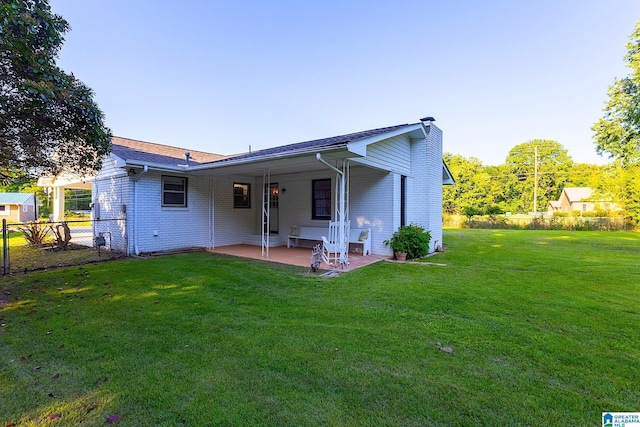 4 Carriage Rd, Anniston, AL 36206 - back of property with a patio, a chimney, and brick siding