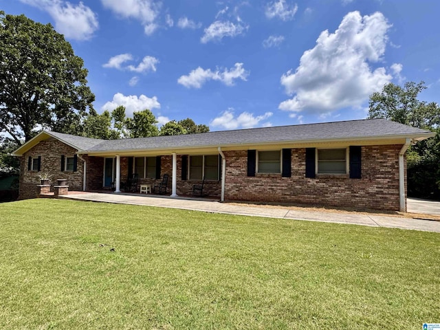 1027 Creek Trl, Anniston, AL 36206 - view of front of property with a front yard, brick siding, and covered porch