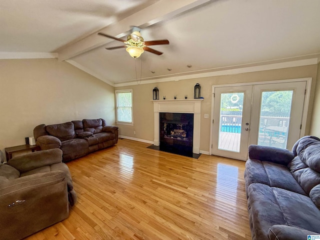 1027 Creek Trl, Anniston, AL 36206 - living area featuring light wood finished floors, ceiling fan, and a fireplace with flush hearth