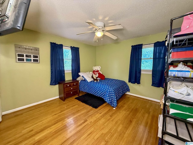 1027 Creek Trl, Anniston, AL 36206 - bedroom with wood finished floors, a textured ceiling, and a ceiling fan