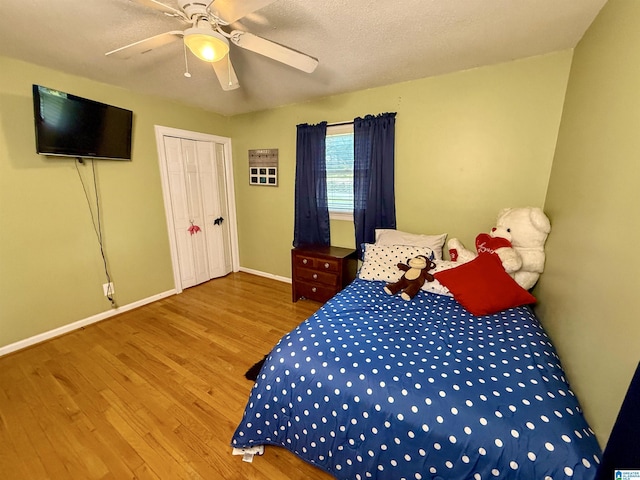 1027 Creek Trl, Anniston, AL 36206 - bedroom featuring wood finished floors, a ceiling fan, and a closet
