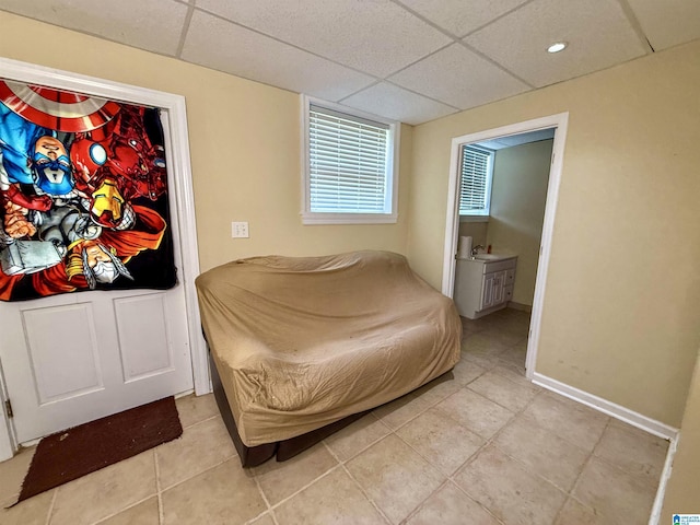 1027 Creek Trl, Anniston, AL 36206 - bedroom featuring a paneled ceiling, light tile patterned floors, and connected bathroom