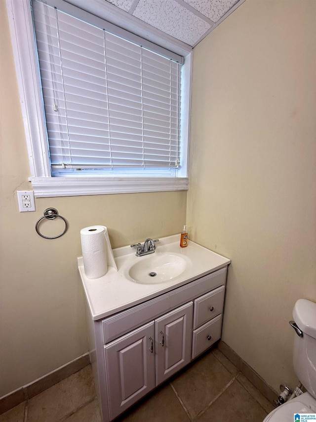 1027 Creek Trl, Anniston, AL 36206 - half bathroom featuring tile patterned floors, vanity, and a drop ceiling