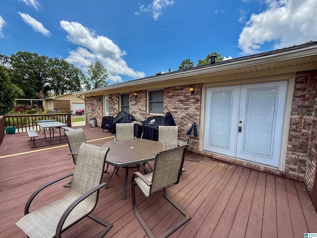 1027 Creek Trl, Anniston, AL 36206 - wooden deck featuring outdoor dining space, french doors, and a grill