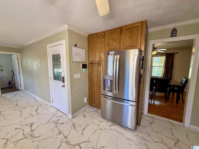 1027 Creek Trl, Anniston, AL 36206 - kitchen featuring stainless steel refrigerator with ice dispenser, light marble finish floors, brown cabinets, ceiling fan, and a textured ceiling