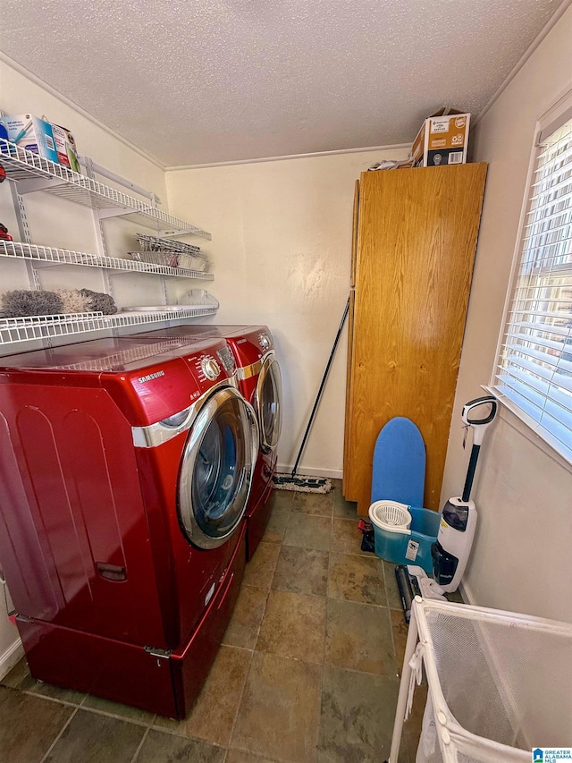1027 Creek Trl, Anniston, AL 36206 - laundry area featuring washing machine and dryer, a textured ceiling, and stone finish flooring