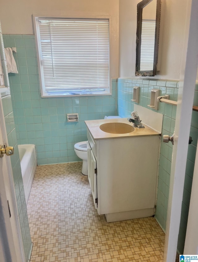 1641 17th Pl SW, Birmingham, AL 35211 - full bathroom with tile walls, vanity, wainscoting, and a tub to relax in