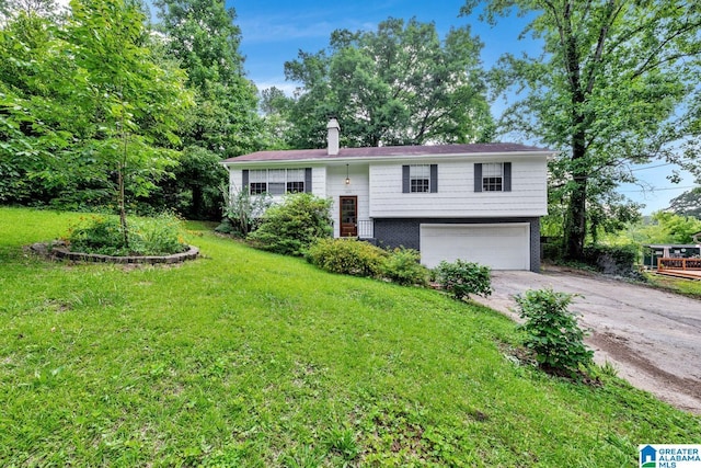 509 Lasalle Ln, Irondale, AL 35210 - bi-level home featuring driveway, an attached garage, a front lawn, and a chimney