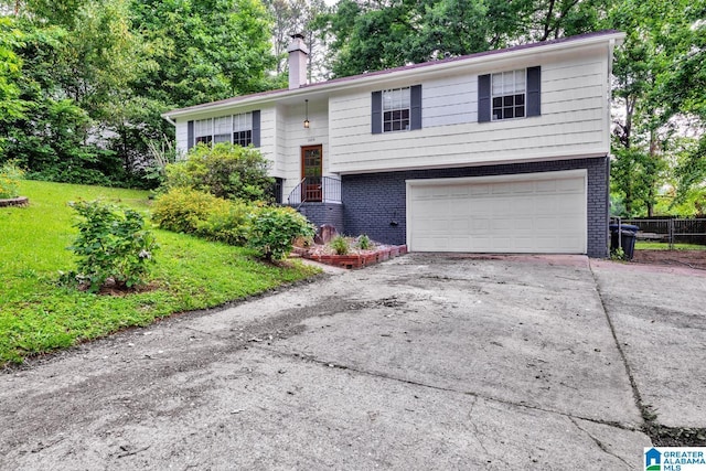 509 Lasalle Ln, Irondale, AL 35210 - raised ranch with a chimney, brick siding, driveway, and an attached garage