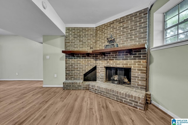 509 Lasalle Ln, Irondale, AL 35210 - unfurnished living room featuring wood finished floors, crown molding, and a fireplace