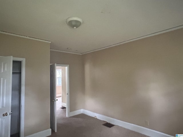2511 20th Pl, Ensley, Birmingham, AL 35208 - unfurnished bedroom featuring dark colored carpet, a closet, and crown molding