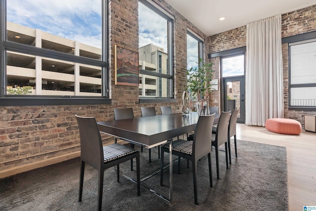 1801 2nd Ave N Unit 415, Birmingham, AL 35203 - dining space featuring brick wall and wood finished floors