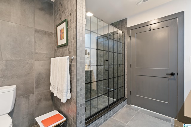 1801 2nd Ave N Unit 415, Birmingham, AL 35203 - bathroom with a shower stall, tile patterned flooring, and tile walls