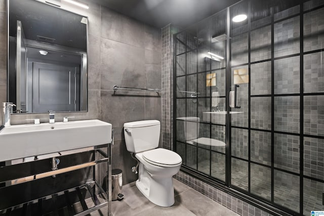 1801 2nd Ave N Unit 415, Birmingham, AL 35203 - full bathroom featuring a stall shower, tile walls, vanity, and tile patterned flooring