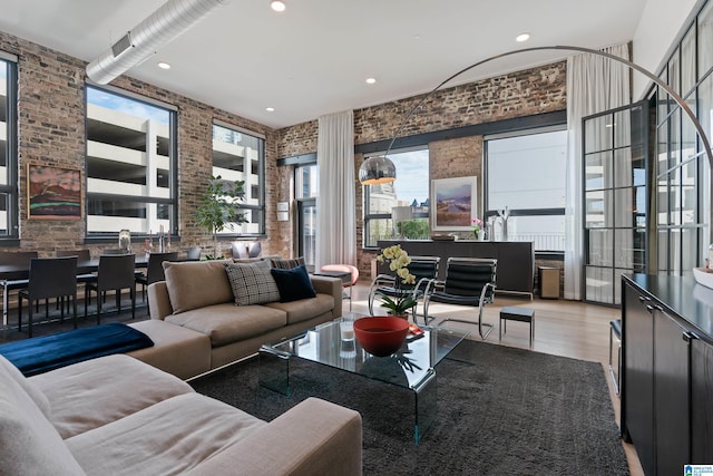 1801 2nd Ave N Unit 415, Birmingham, AL 35203 - living area with brick wall, wood finished floors, plenty of natural light, and recessed lighting