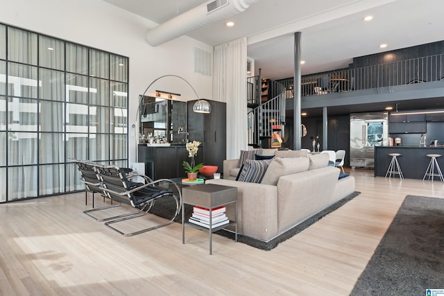 1801 2nd Ave N Unit 415, Birmingham, AL 35203 - living room with wood finished floors, a towering ceiling, and stairs