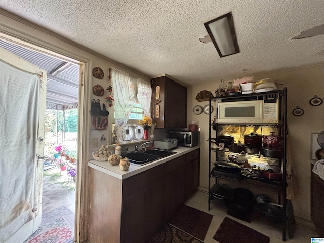 92 Briar Hill Loop, Wetumpka, AL 36092 - kitchen featuring white microwave, stainless steel microwave, a textured ceiling, and light countertops