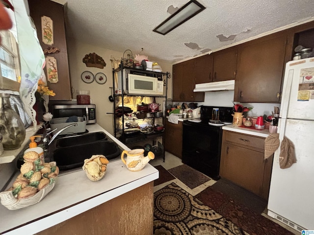 92 Briar Hill Loop, Wetumpka, AL 36092 - kitchen featuring white appliances, under cabinet range hood, light countertops, a textured ceiling, and dark brown cabinets