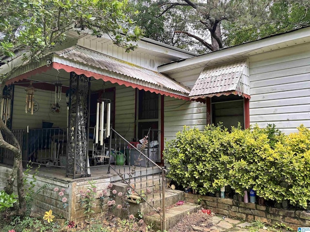92 Briar Hill Loop, Wetumpka, AL 36092 - view of exterior entry with covered porch and a metal roof