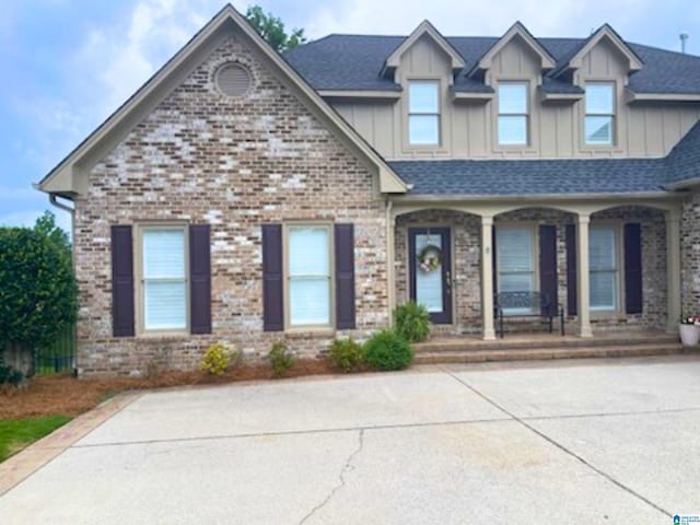 5557 Lakes Edge Dr, Hoover, AL 35242 - view of front of home with a porch, board and batten siding, and brick siding