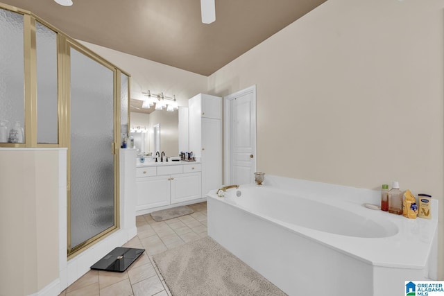 5557 Lakes Edge Dr, Hoover, AL 35242 - full bath featuring a shower stall, vanity, tile patterned floors, a garden tub, and ceiling fan