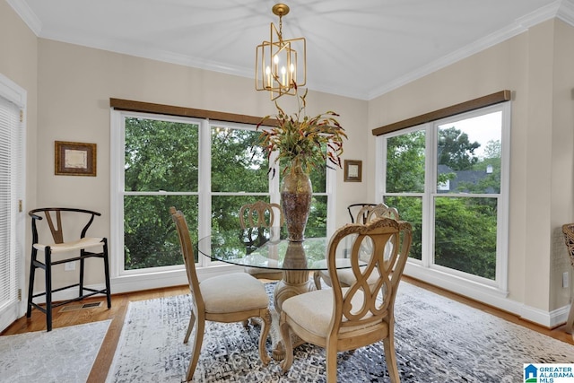 5557 Lakes Edge Dr, Hoover, AL 35242 - dining space featuring wood finished floors, crown molding, and a chandelier