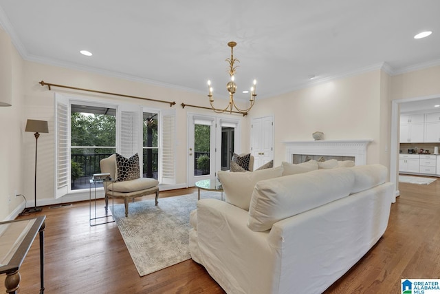 5557 Lakes Edge Dr, Hoover, AL 35242 - living area featuring ornamental molding, a chandelier, wood finished floors, and recessed lighting