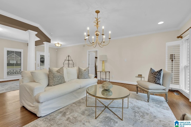 5557 Lakes Edge Dr, Hoover, AL 35242 - living area with decorative columns, wood finished floors, crown molding, recessed lighting, and a chandelier