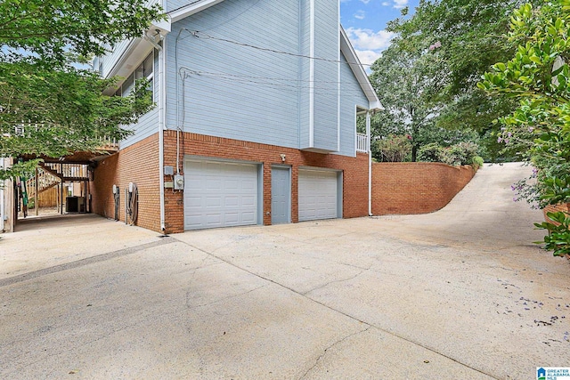 505 Waterside Cir, Mccalla, AL 35111 - view of side of property with brick siding, an attached garage, driveway, and a chimney