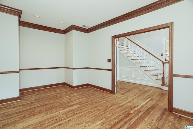 3357 Afton Ln, Birmingham, AL 35242 - spare room featuring light wood-style floors, ornamental molding, stairway, and recessed lighting