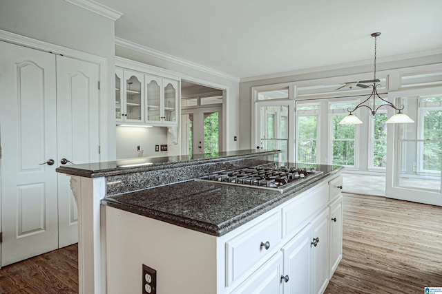 3357 Afton Ln, Birmingham, AL 35242 - kitchen with stainless steel gas cooktop, crown molding, white cabinetry, dark wood finished floors, and a kitchen island