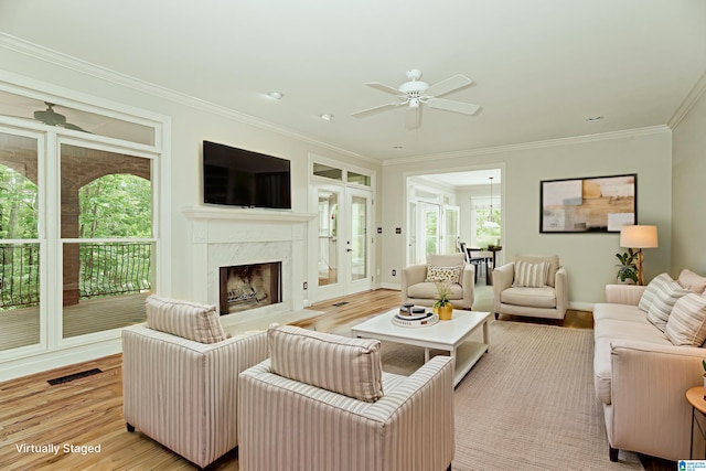3357 Afton Ln, Birmingham, AL 35242 - living area featuring crown molding, light wood-style floors, a ceiling fan, and a premium fireplace