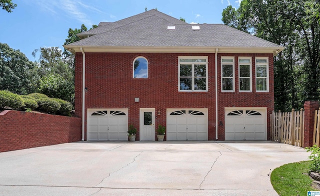 3357 Afton Ln, Birmingham, AL 35242 - view of property exterior featuring driveway, roof with shingles, a garage, and brick siding