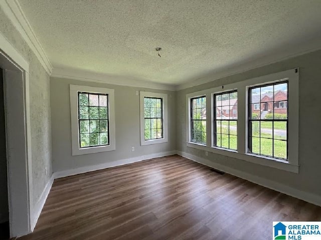 1511 43rd St, Birmingham, AL 35208 - unfurnished room featuring a textured ceiling, healthy amount of natural light, dark wood-style floors, and ornamental molding