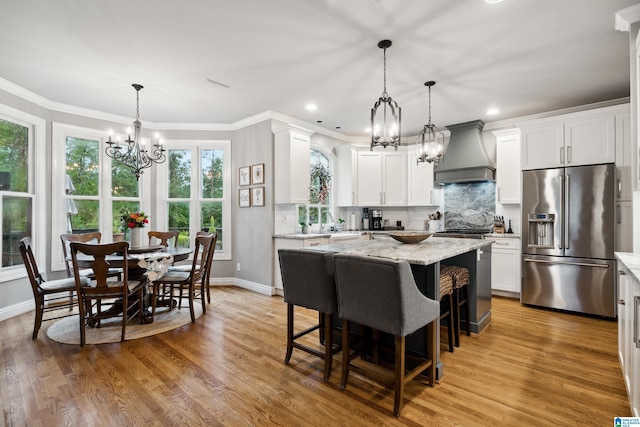 4067 Milners Cres, Hoover, AL 35242 - kitchen with high quality fridge, a chandelier, custom exhaust hood, light stone countertops, and tasteful backsplash
