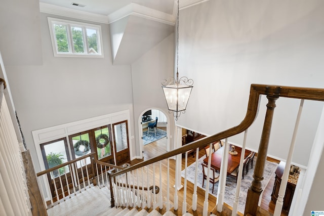 4067 Milners Cres, Hoover, AL 35242 - stairs with a chandelier, wood finished floors, ornamental molding, and arched walkways