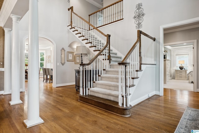 4067 Milners Cres, Hoover, AL 35242 - stairs with arched walkways, wood finished floors, a high ceiling, decorative columns, and ornamental molding