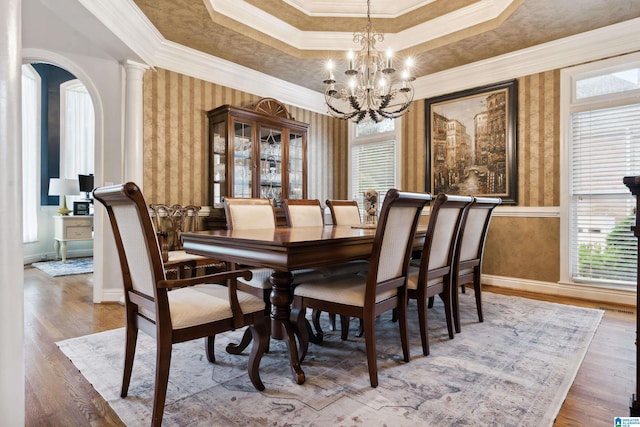 4067 Milners Cres, Hoover, AL 35242 - dining space with wallpapered walls, healthy amount of natural light, a chandelier, crown molding, and wood finished floors