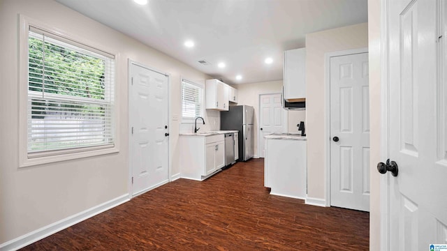 2653 NE Janice Cir, Birmingham, AL 35235 - kitchen featuring stainless steel appliances, light countertops, dark wood-style floors, white cabinets, and recessed lighting