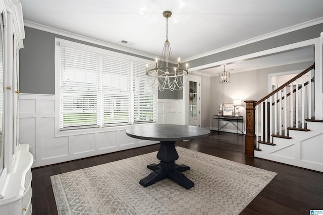 2725 Griffin Way, Hoover, AL 35244 - dining area with a chandelier, a decorative wall, ornamental molding, dark wood finished floors, and wainscoting