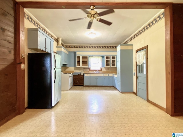 672 Websters Chapel Rd, Wellington, AL 36279 - kitchen with freestanding refrigerator, blue cabinets, ceiling fan, white range, and light flooring
