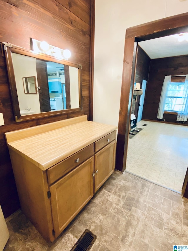 672 Websters Chapel Rd, Wellington, AL 36279 - bathroom featuring wood walls, stone finish flooring, and vanity