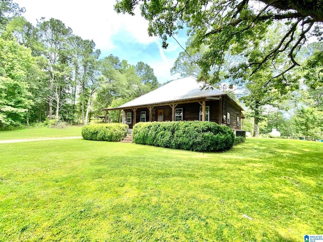 672 Websters Chapel Rd, Wellington, AL 36279 - view of front facade with a front yard, log exterior, and covered porch